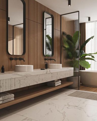 Salle de bain moderne avec double vasque, plantes et grandes fenêtres.