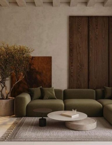 Canapé vert moderne avec table ronde et éléments en bois dans un intérieur minimaliste.