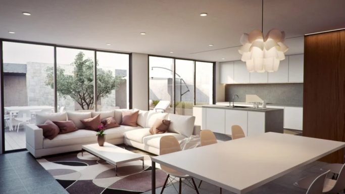 Intérieur moderne d'un salon lumineux avec canapé, table et cuisine ouverte.
